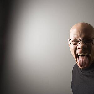 Portrait of mid-adult Caucasian male sticking out tongue.