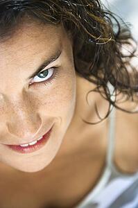 Woman looking up at viewer smiling