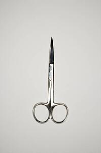 Scissors on gray background.