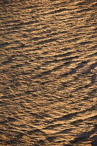 Rippled Atlantic ocean water with sun reflection