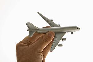 Hand holding toy airplane 