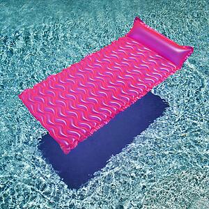 Pink float in empty swimming pool with rippling blue pool.