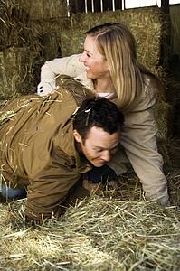 Couple playing in hay