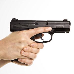 Close up of mid adult female Caucasian law enforcement officer hands on gun aiming.