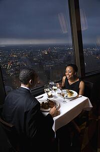 Couple having dinner near a window with a view