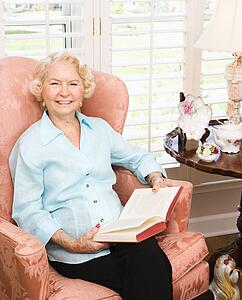 Woman sitting in chair reading a book
