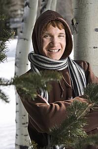 Portrait of a male teenager wearing hoodie and scarf in winter setting
