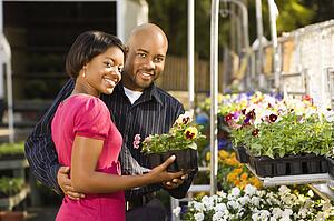 Smiling couple picking out flowers 