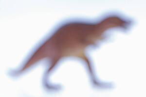 Blurred toy Tyrannosaurus dinosaur.