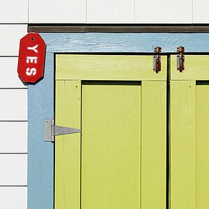 Detail of colorful doors with sign reading 'yes' at Bald Head Island, North Carolina.