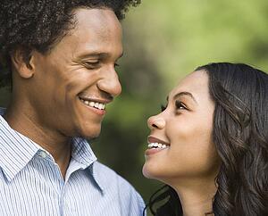 Portrait of smiling couple looking into each other's eyes.