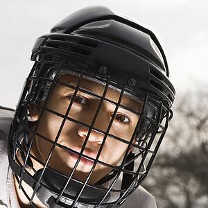 Boy in ice hockey uniform making eye contact