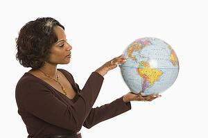Woman holding world globe out between hands