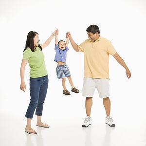 Mother and father holding hands with son