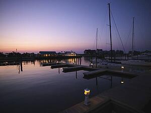 Ferry boat and sail boats at marina at dusk at Bald Head Island, North Carolina