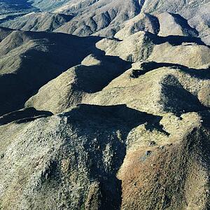 Aerial view of Arizona landscape with mountain range.