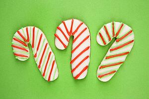 Candy cane sugar cookies with decorative icing.