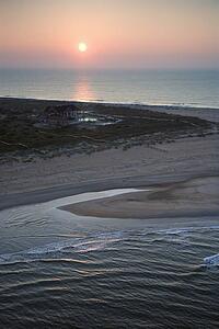 Scenic aerial view of Baldhead Island, North Carolina beach at dusk.