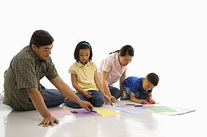 Parents sitting on floor with children