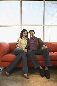 Young couple sitting on couch.