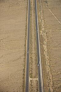 Aerial view of interstate through desert landscape.