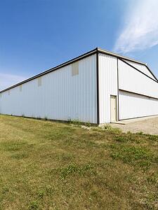 Plain large aluminum building in rural setting