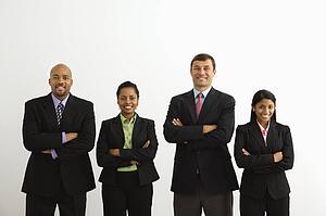 Portrait of businessmen and businesswomen standing smiling with arms crossed