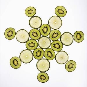 Kiwi and lime fruit slices arranged on white background.