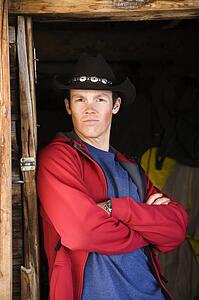 Man wearing cowboy hat with arms crossed 