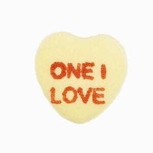 Yellow candy heart that reads one I love against white background.