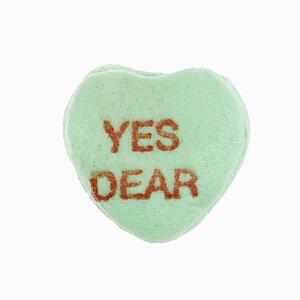 Green candy heart that reads yes dear against white background.