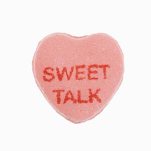 Pink candy heart that reads sweet talk against white background.