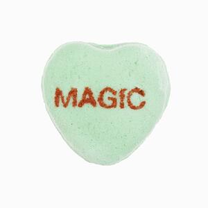 Green candy heart that reads magic against white background.