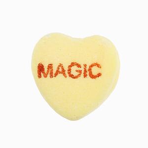 Yellow candy heart that reads magic against white background.