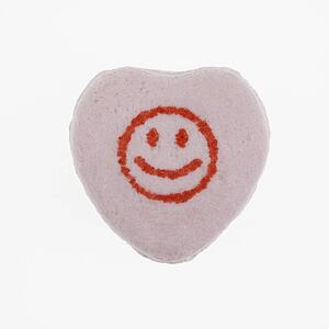 Purple candy heart with smiley face against white background.