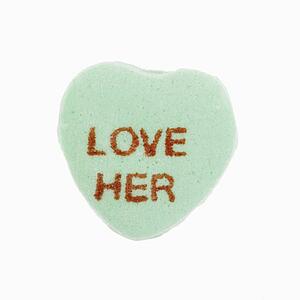 Green candy heart that reads love her against white background.