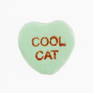 Green candy heart that reads cool cat against white background.