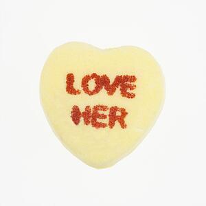 Yellow candy heart that reads love her against white background.