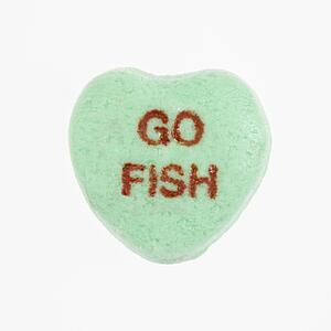 Green candy heart that reads go fish against white background.