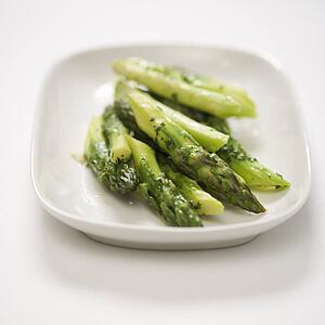 Plate of green cooked asparagus.