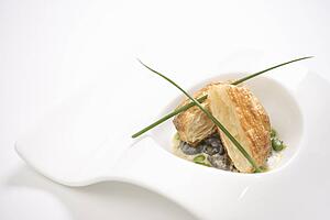 Escargot en croute with butter and fava beans.