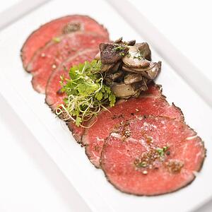 Pepper charred beef carpaccio with mushrooms.