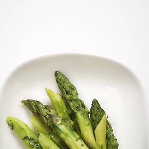 Plate of green cooked asparagus.