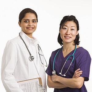 Indian and Asian mid adult woman doctors portrait on white background.