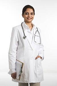Indian woman doctor portrait standing against white background.