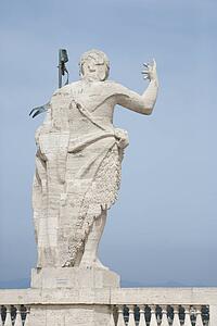 Back view of Roman statue with blue sky in Rome, Italy.