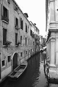 Canal with boat and buildings in Venice, Italy.