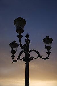 Streetlamp with sunset sky in background in Rome, Italy.