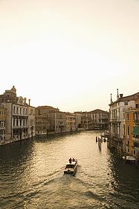 Buildings and boat on canal in Venice, Italy.