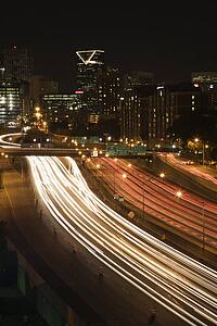 Nightscape of Atlanta, Georgia skyline with blurred automobile lights on highway in foreground.